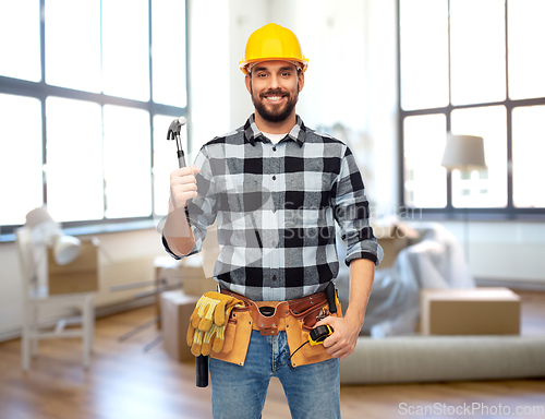 Image of happy male builder in helmet with hammer at home