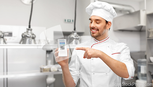 Image of chef with virtual immunity passport on smartphone