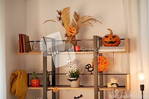 Image of shelf with halloween decorations at home