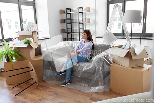 Image of happy asian woman with stuff moving to new home