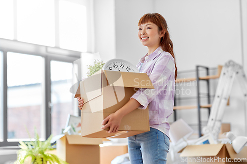 Image of happy woman unpacking boxes and moving to new home