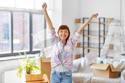 Image of happy asian woman with stuff moving to new home