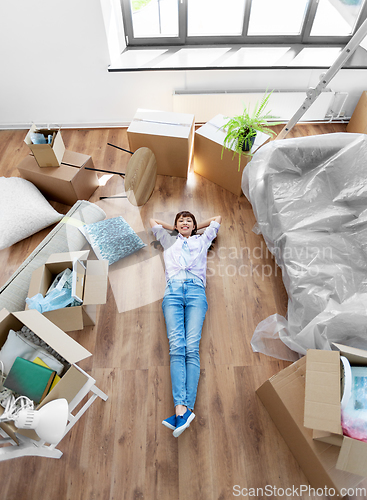 Image of happy woman with boxes moving to new home