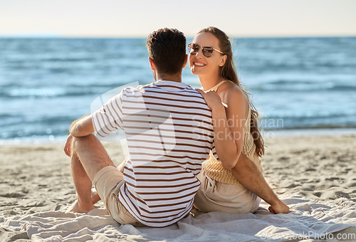 Image of happy couple hugging on summer beach