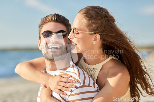 Image of happy couple hugging on summer beach