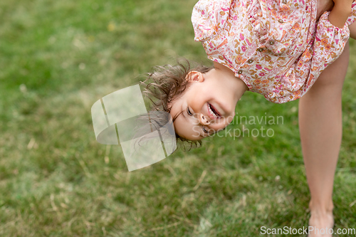 Image of happy smiling little baby girl having fun outdoors