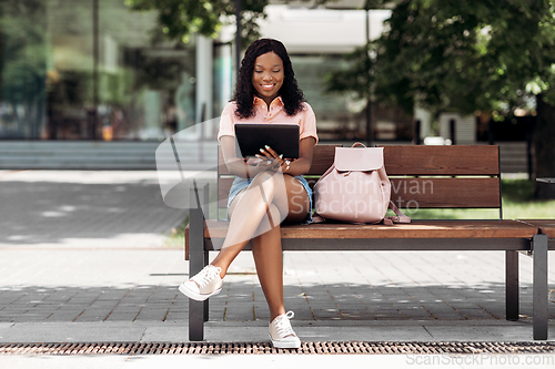 Image of african american woman with tablet pc in city