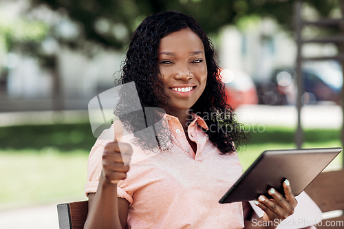 Image of african american woman with tablet pc in city