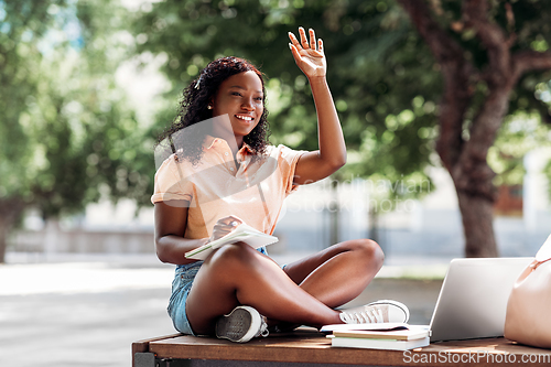 Image of african student girl with laptop and books in city