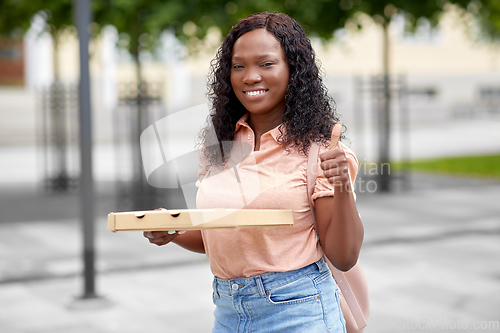 Image of african student girl with pizza showing thumbs up