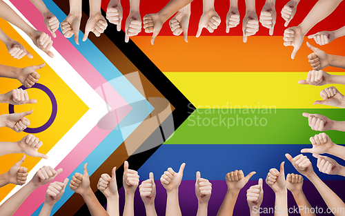 Image of hands showing thumbs up over progress pride flag