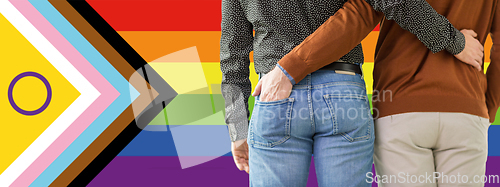 Image of close up of male gay couple over pride flag