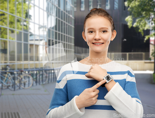 Image of teenage girl showing smart watch with qr code