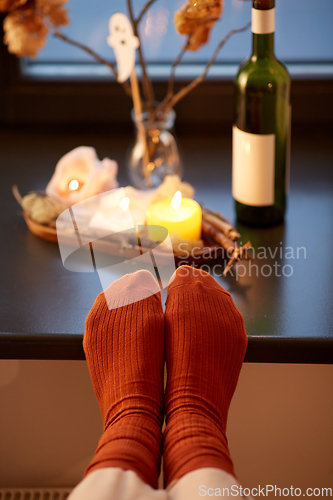 Image of feet in socks on window sill at home in autumn