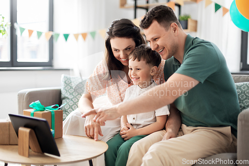 Image of happy family with tablet pc at home on birthday