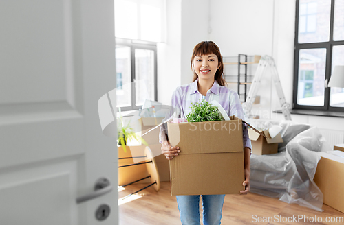 Image of happy woman unpacking boxes and moving to new home