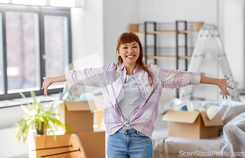 Image of happy asian woman with stuff moving to new home