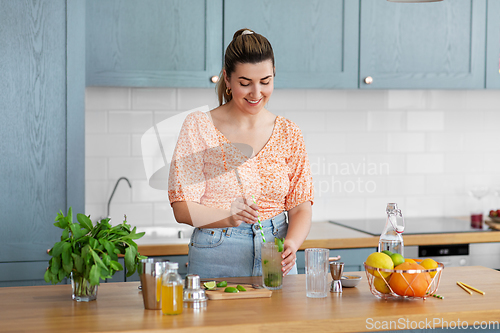 Image of woman making cocktail drinks at home kitchen