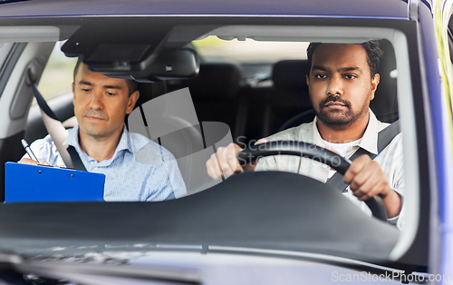 Image of car driving school instructor and young driver