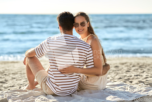 Image of happy couple hugging on summer beach