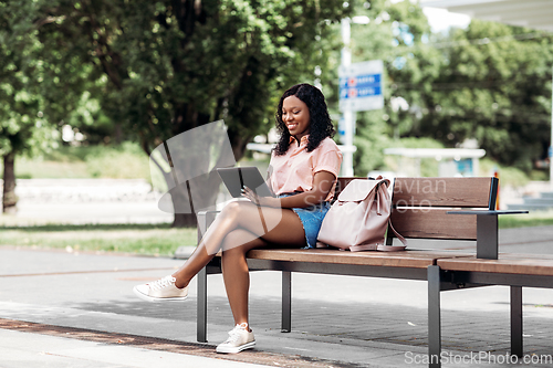 Image of african american woman with tablet pc in city