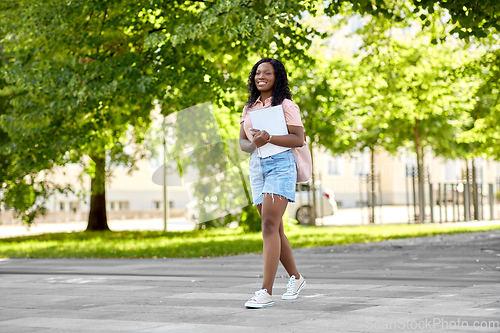 Image of african student girl with notebooks in city