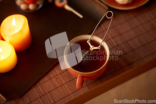 Image of mesh tea infuser ball in ceramic mug on halloween