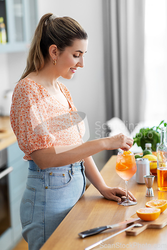 Image of woman making cocktail drinks at home kitchen