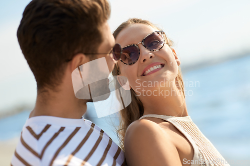 Image of portrait of happy couple on summer beach