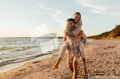 Image of happy couple having fun on summer beach