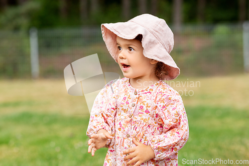 Image of happy little baby girl outdoors in summer