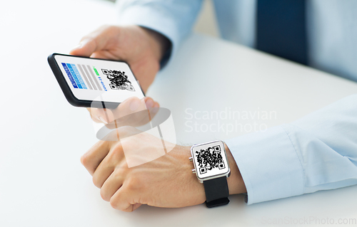 Image of hands with virtual immunity passport on smartphone