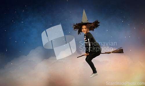 Image of girl in black witch hat with broom on halloween