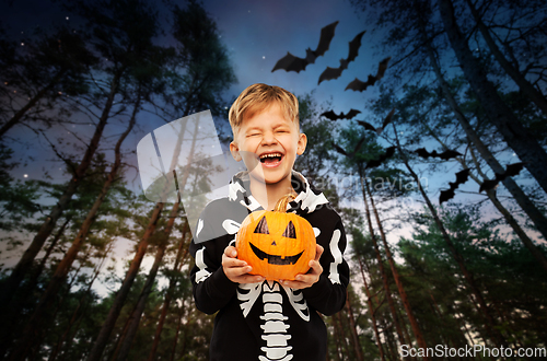 Image of happy boy in halloween costume with jack-o-lantern