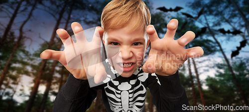 Image of boy in halloween costume of skeleton making faces