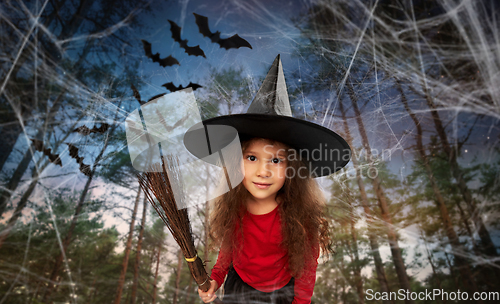 Image of girl in black witch hat with broom on halloween