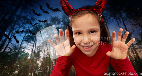 Image of girl costume with devil's horns on halloween