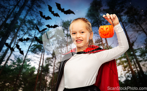 Image of girl in halloween costume of dracula with pumpkin