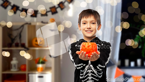 Image of boy in halloween costume with jack-o-lantern