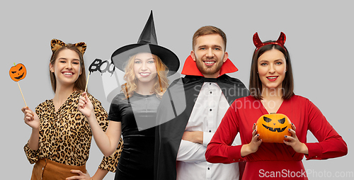 Image of happy smiling friends in halloween costumes