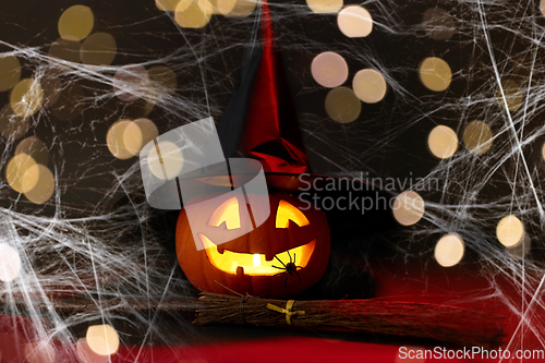 Image of halloween jack-o-lantern in witch's hat and broom