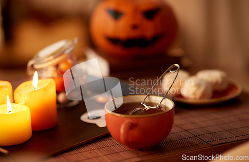 Image of mesh tea infuser ball in ceramic mug on halloween