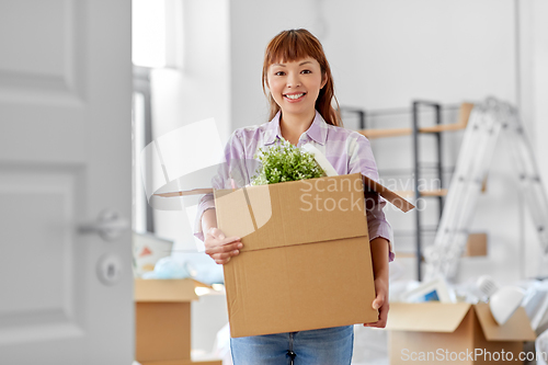 Image of happy woman unpacking boxes and moving to new home