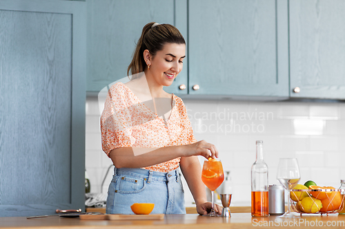 Image of woman making cocktail drinks at home kitchen