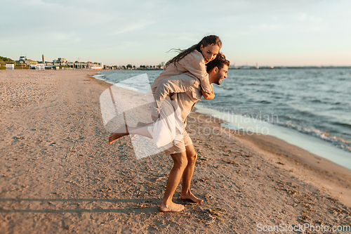 Image of happy couple having fun on summer beach