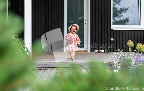 Image of happy little baby girl having fun outdoors