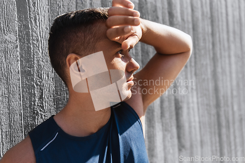 Image of portrait of tired young man doing sports outdoors