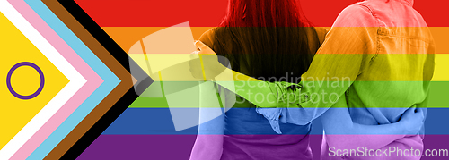 Image of close up of female gay couple over pride flag