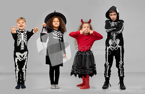 Image of children in halloween costumes trick-or-treating