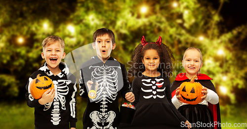 Image of children in halloween costumes trick-or-treating